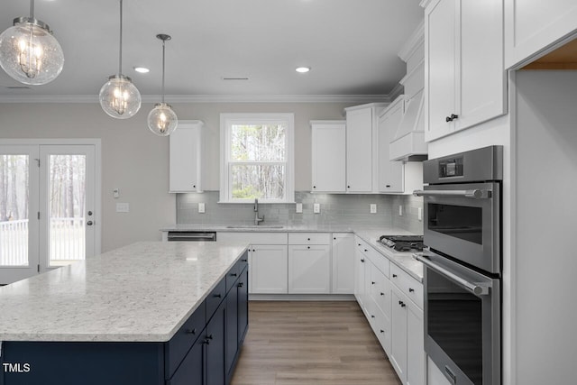 kitchen featuring tasteful backsplash, ornamental molding, stainless steel appliances, and a sink