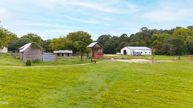 view of yard featuring an outbuilding and fence