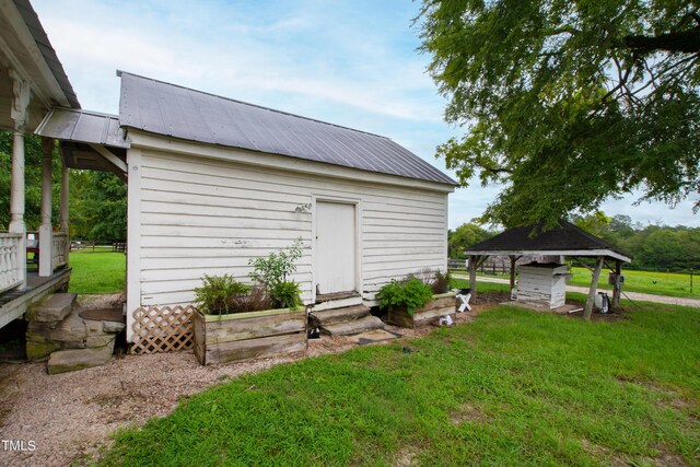 view of outdoor structure featuring a gazebo and a lawn