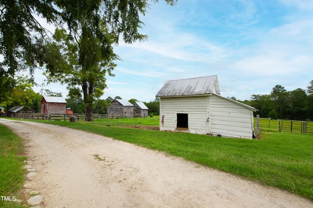 exterior space with an outbuilding and fence