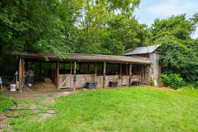 exterior space featuring an outbuilding and a lawn