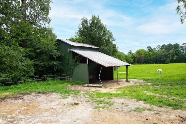 exterior space featuring a carport, a lawn, and a rural view