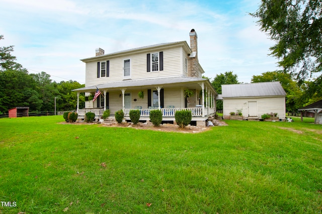 view of front of house featuring a front lawn, covered porch, and a shed