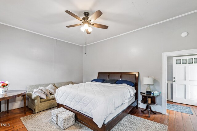 bedroom with ceiling fan, wood-type flooring, and ornamental molding