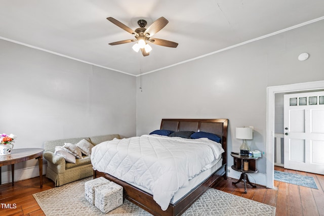 bedroom with wood finished floors, a ceiling fan, and crown molding