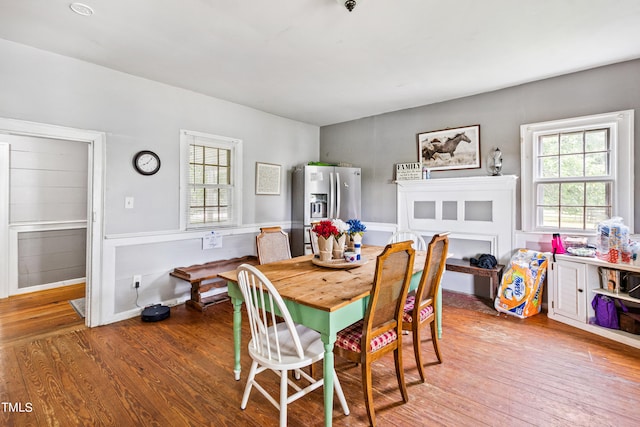 dining space with wood-type flooring