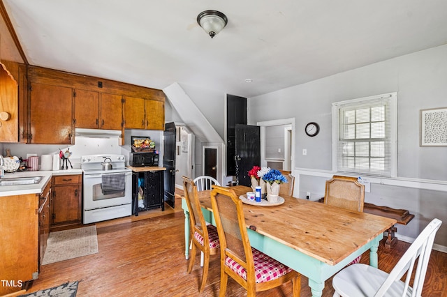 dining area featuring light wood finished floors and baseboards