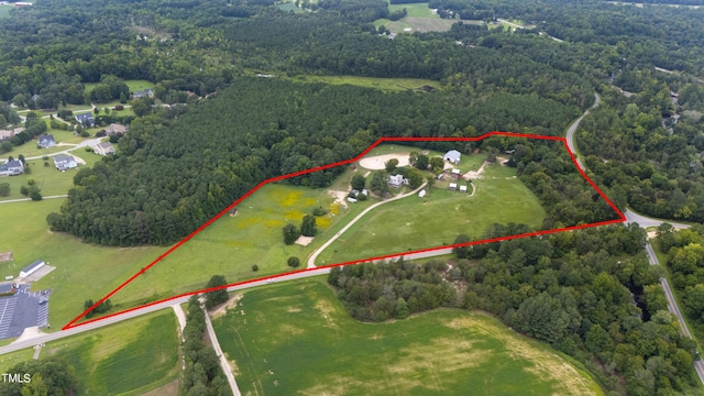 birds eye view of property featuring a wooded view