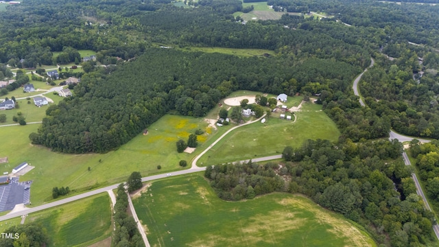 bird's eye view with a wooded view