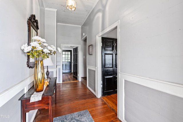 corridor with crown molding and wood-type flooring