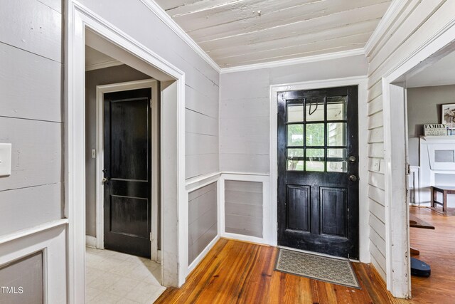 foyer with hardwood / wood-style floors and crown molding