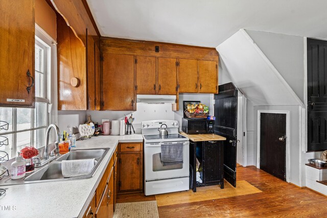 kitchen with white range with electric cooktop, sink, and light hardwood / wood-style floors