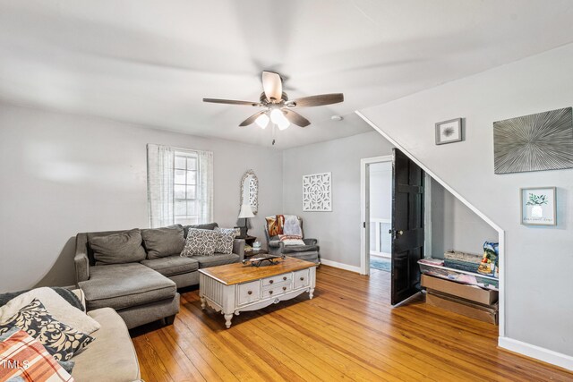 living room featuring hardwood / wood-style floors and ceiling fan