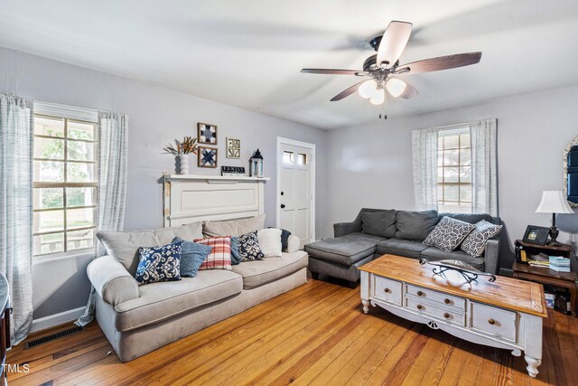 living room featuring ceiling fan and light wood-type flooring