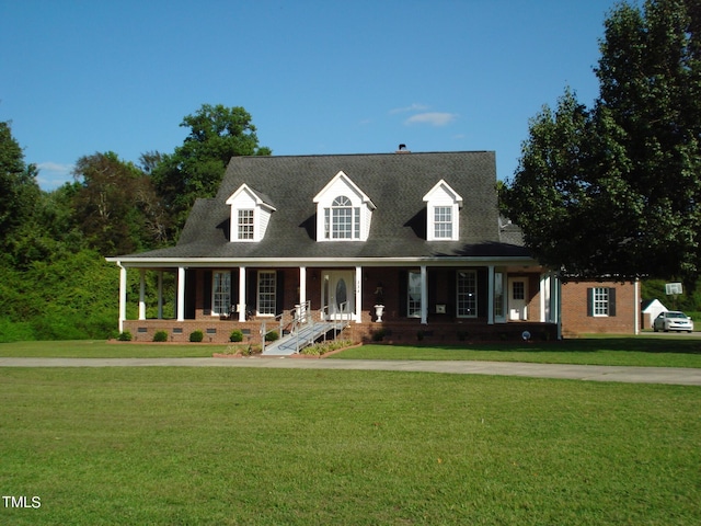 cape cod house with a front lawn and a porch