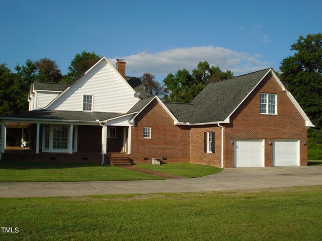 view of property with a garage and a front yard