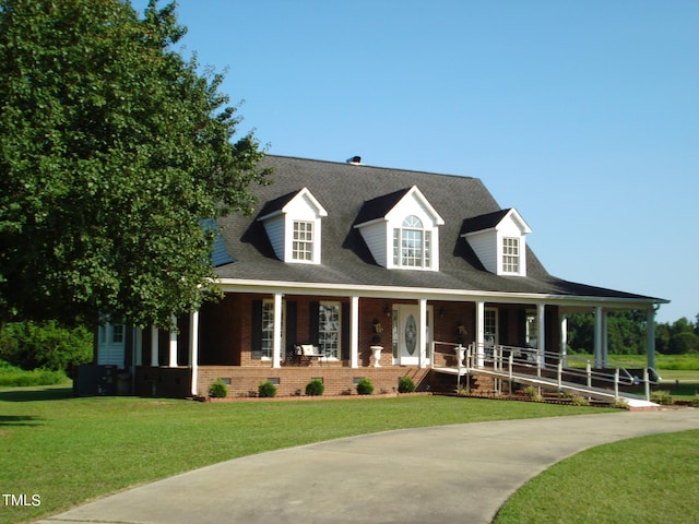 view of front of home with a front yard and covered porch