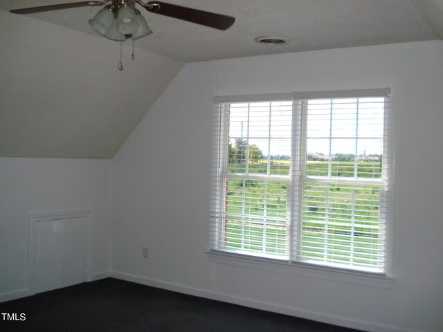 bonus room with a healthy amount of sunlight, vaulted ceiling, and ceiling fan