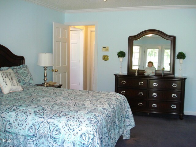 bedroom featuring ornamental molding and dark carpet