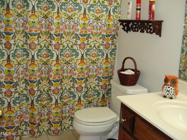 bathroom featuring vanity, toilet, and tile patterned flooring