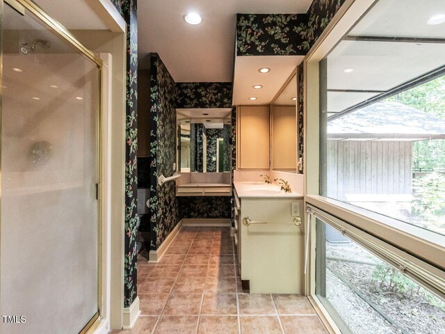 bathroom with vanity, tile patterned floors, and walk in shower