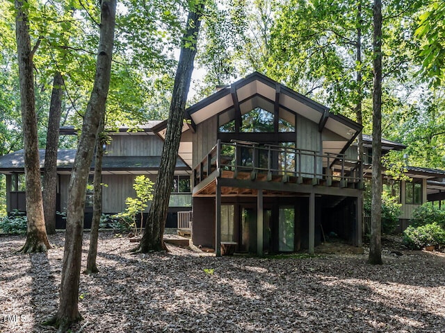 back of property featuring a wooden deck