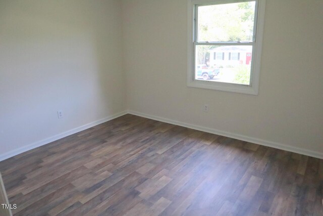 empty room with dark wood-type flooring