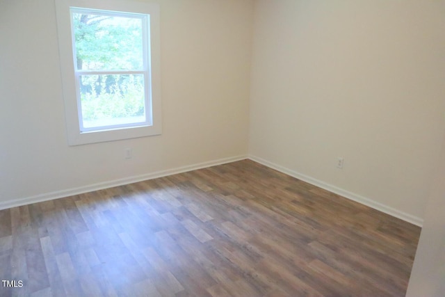 spare room with dark hardwood / wood-style flooring