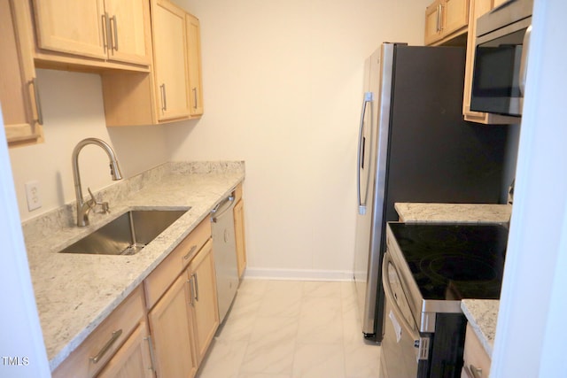 kitchen with stainless steel appliances, sink, light tile patterned floors, light stone countertops, and light brown cabinetry