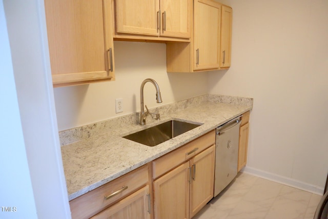 kitchen featuring sink, light stone counters, light tile patterned floors, stainless steel dishwasher, and light brown cabinetry