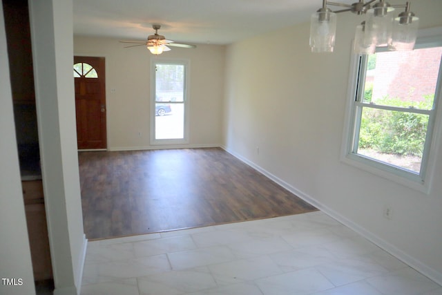 unfurnished room featuring light tile patterned floors, a wealth of natural light, and ceiling fan