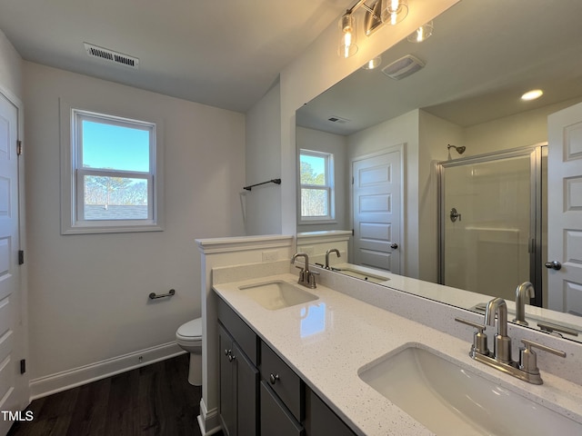 bathroom with vanity, toilet, wood-type flooring, and walk in shower