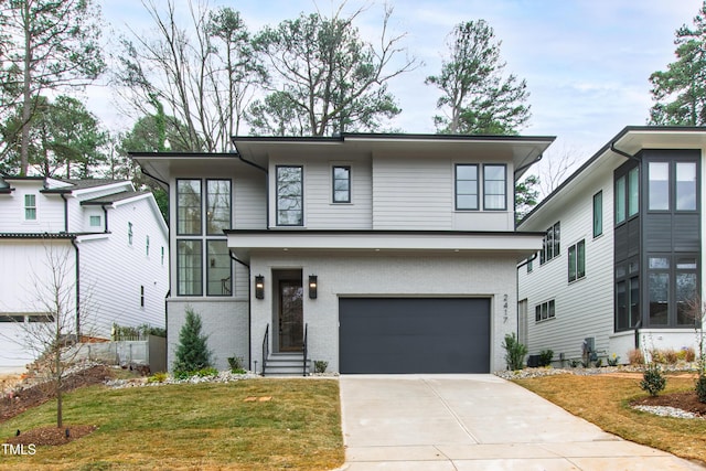 modern home featuring a garage and a front lawn