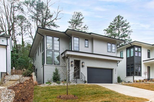 view of front of house with a garage and a front lawn