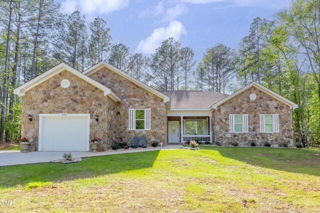 ranch-style house featuring a garage and a front lawn