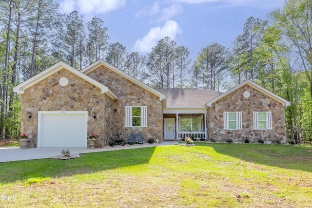 view of front of house with driveway, a front lawn, an attached garage, and a shingled roof