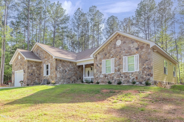 view of front facade with a front lawn, covered porch, and a garage