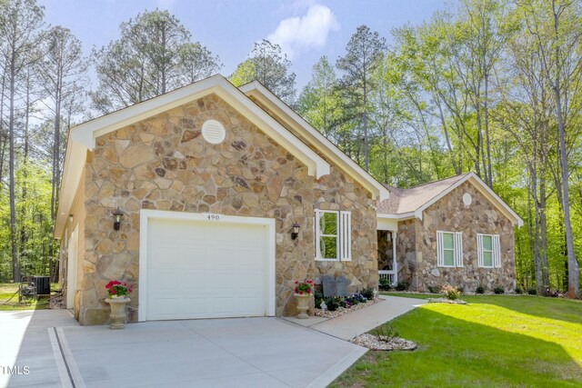 view of front of home with central air condition unit and a front lawn