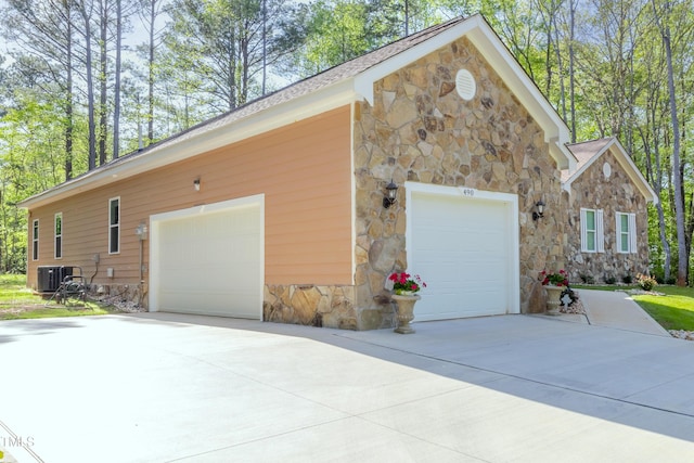 view of property exterior featuring stone siding and central air condition unit