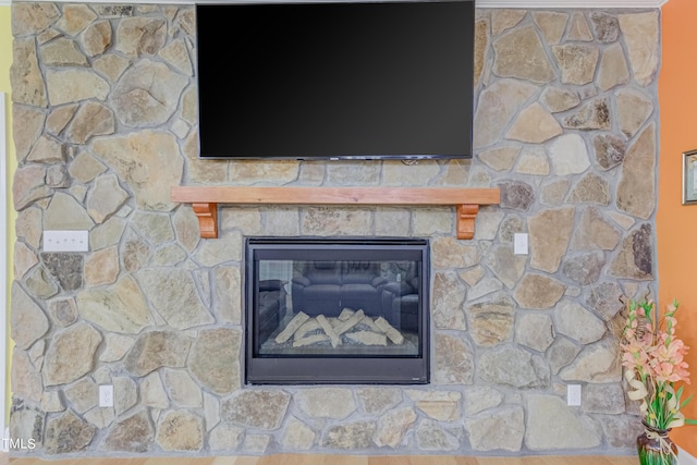 interior details featuring a glass covered fireplace