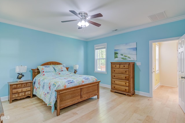 bedroom with crown molding, baseboards, visible vents, and light wood finished floors