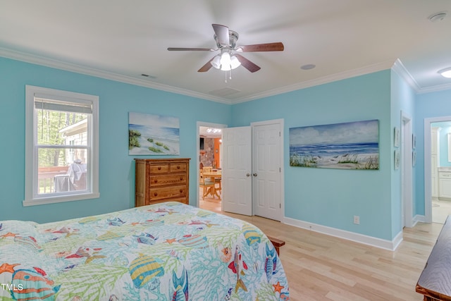 bedroom featuring visible vents, baseboards, ornamental molding, light wood-type flooring, and connected bathroom