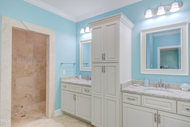 full bathroom featuring a sink, tiled shower, two vanities, and ornamental molding