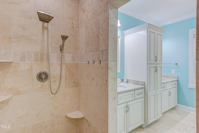 full bath with vanity, tiled shower, baseboards, and ornamental molding