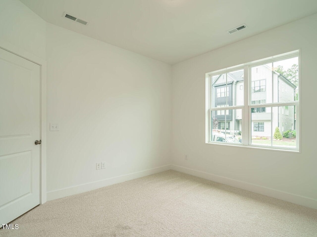 unfurnished room with light carpet