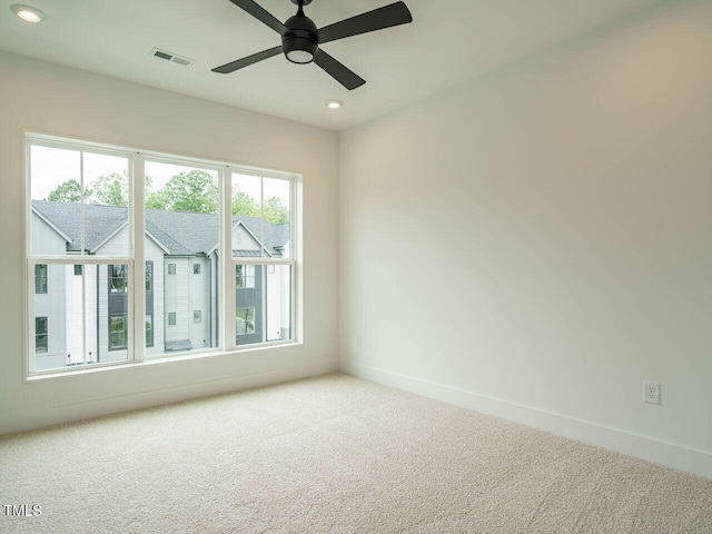 spare room featuring carpet floors and ceiling fan