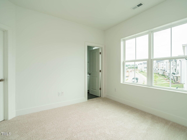 empty room with light colored carpet