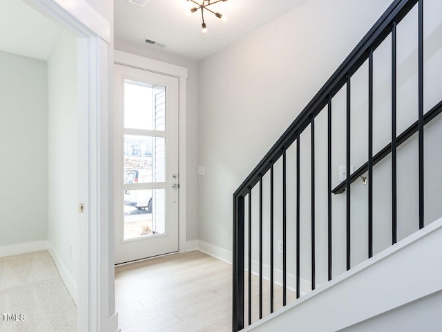 interior space with visible vents, baseboards, and wood finished floors