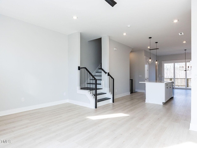 interior space featuring stairs, light wood-type flooring, and recessed lighting