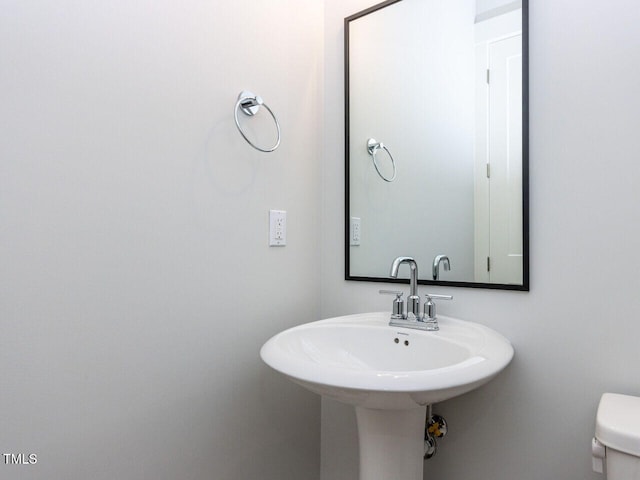 bathroom featuring toilet and a sink